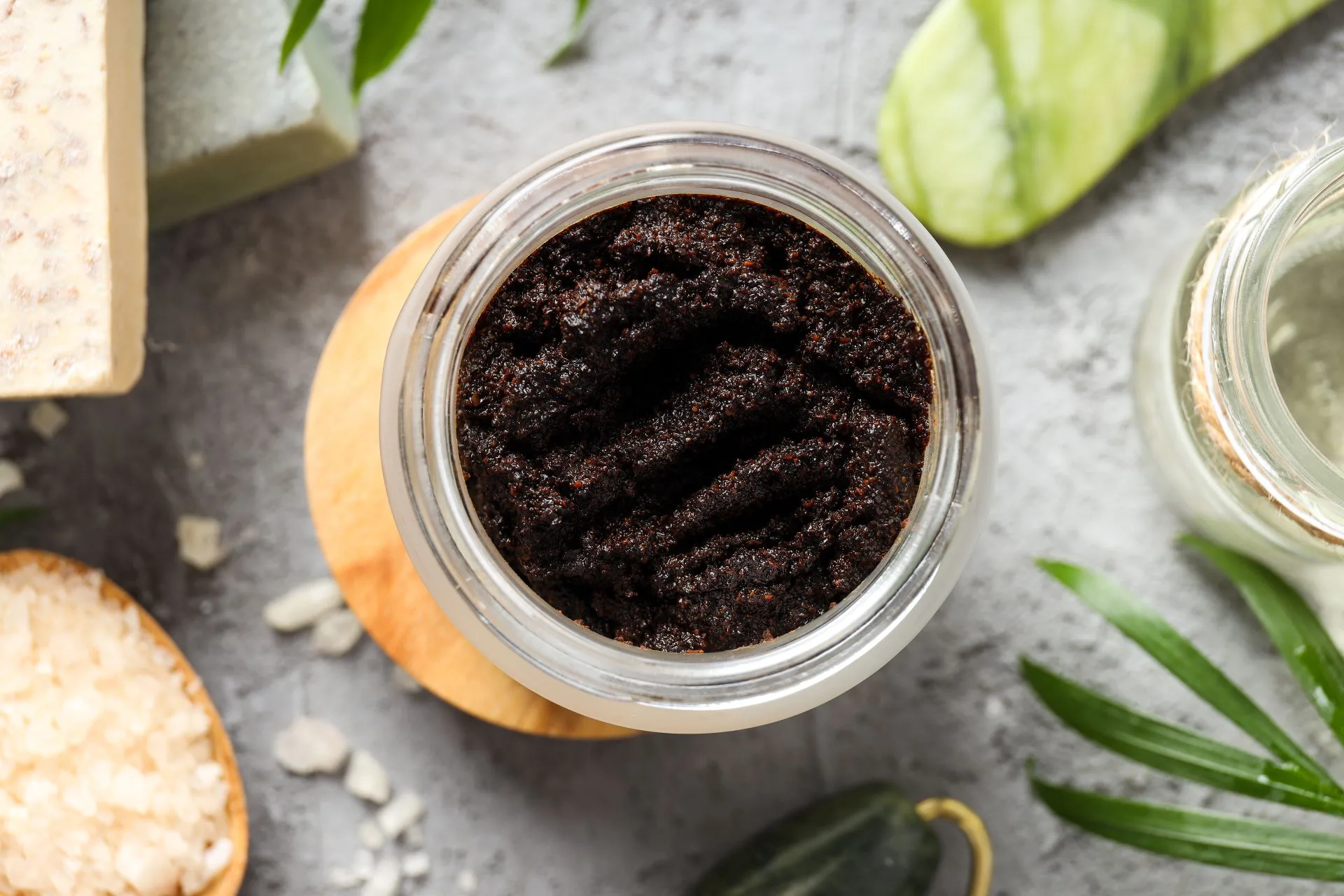 Jar of coffee scrub with natural ingredients.