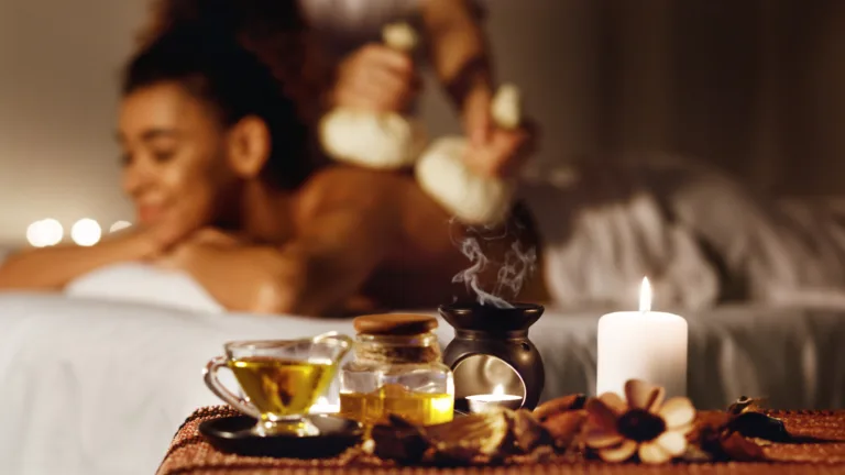 Relaxing massage therapy with oils and candlelight.