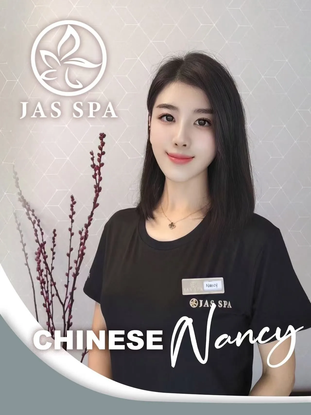 JAS SPA employee wearing black shirt, badge visible.