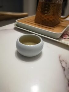 White ceramic teacup on a marble table.