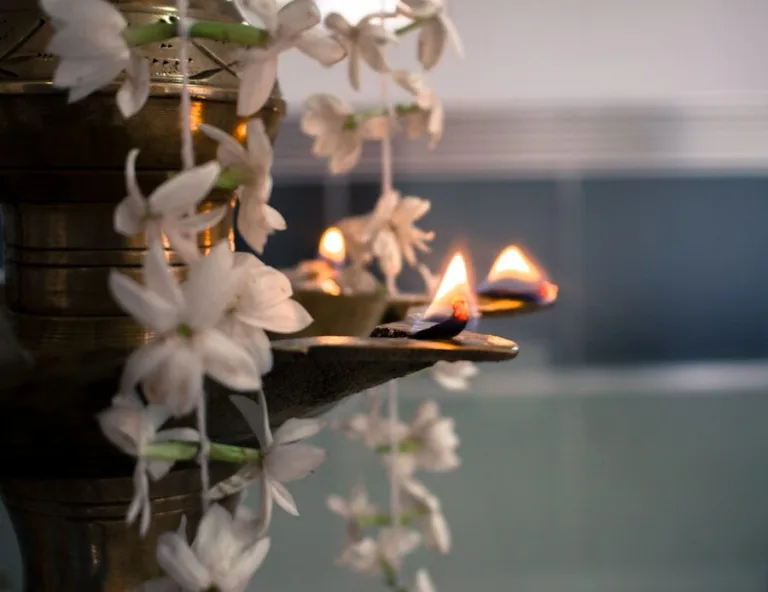 Lit oil lamps and hanging white flowers