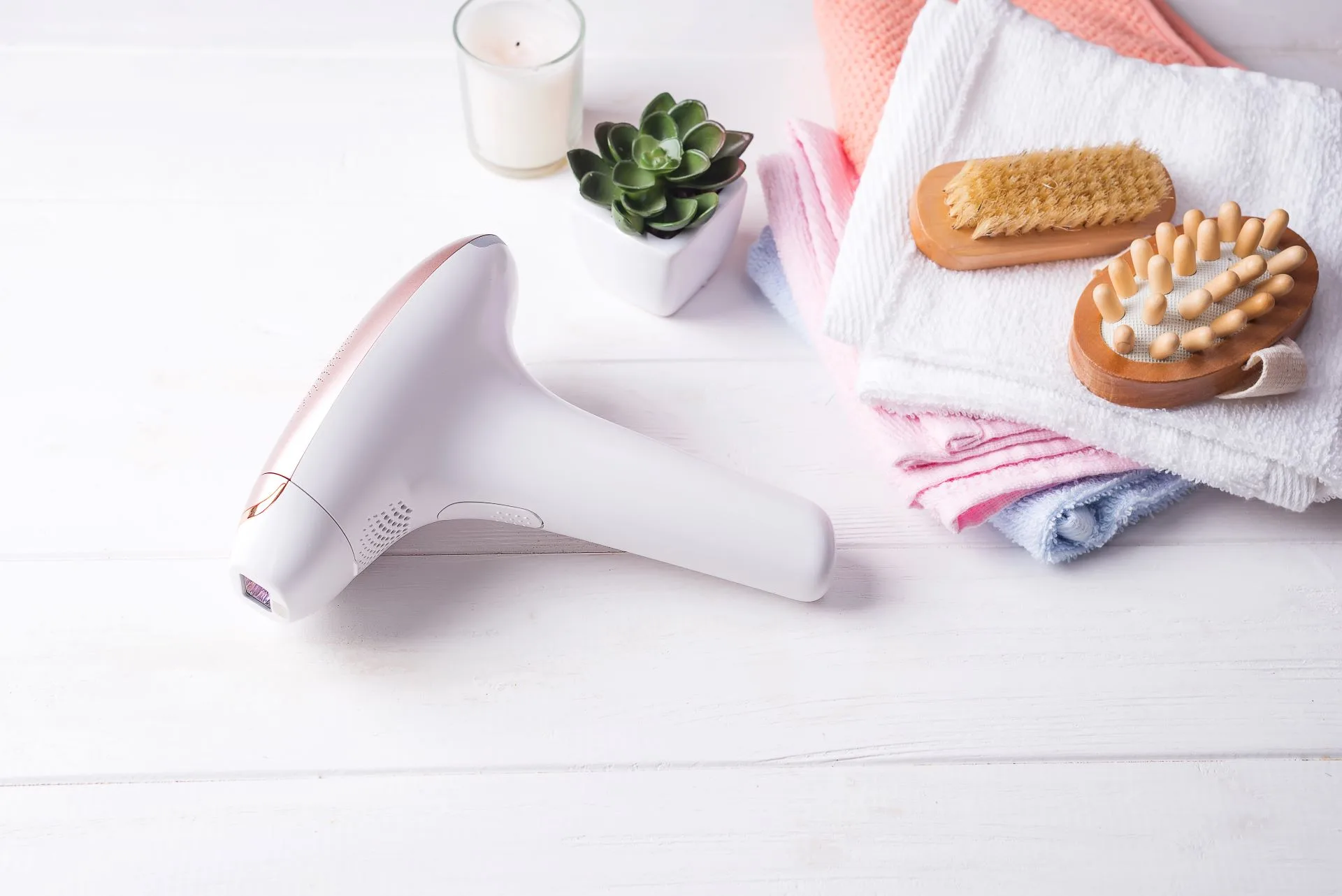Hair removal device and spa essentials on table.