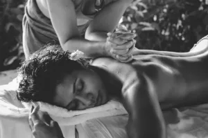 Person receiving relaxing back massage outdoors.