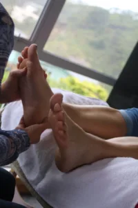 Foot massage session by a window.
