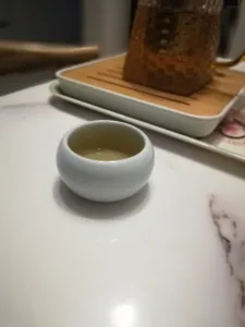 White ceramic teacup on a marble table.